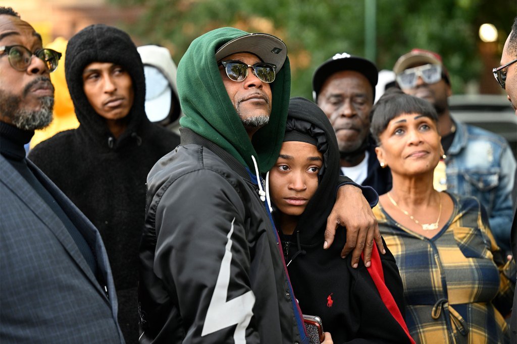 Shayma’s older sister Tayma Roman (19) who was with her when she was shot is consoled by her father Mario Roman at the vigil.