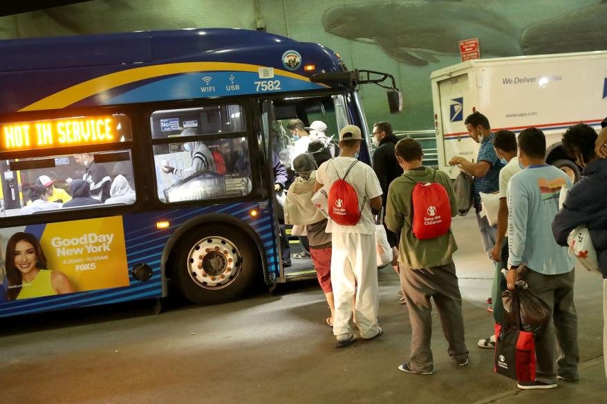 Migrants boarding a MTA bus at Port Authority.