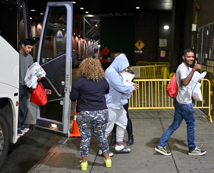 A picture of migrants getting off a bus at Port Authority in NYC.