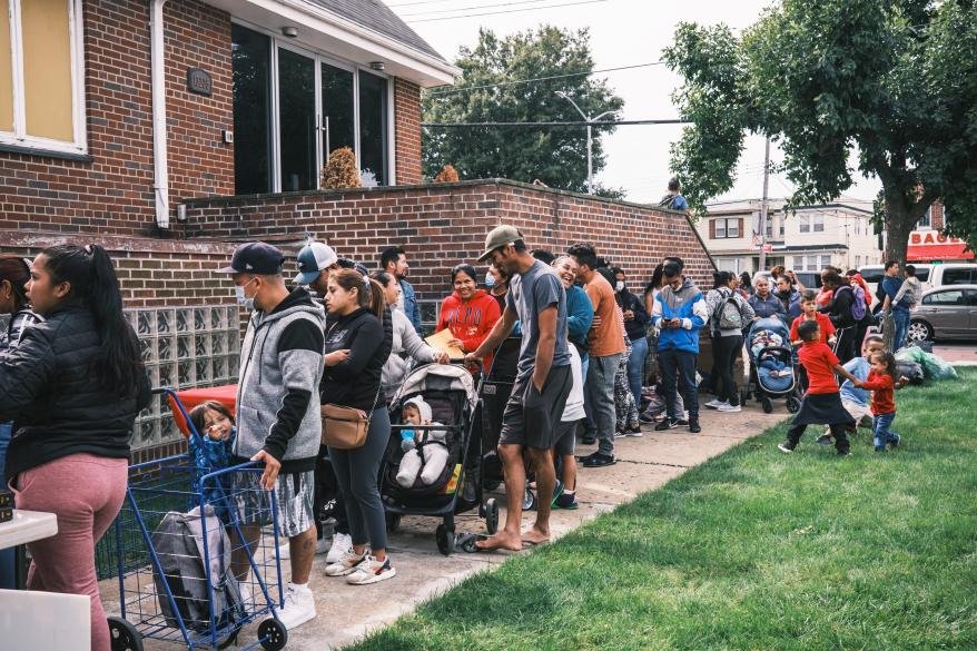 Images of migrant families receiving clothing donations.