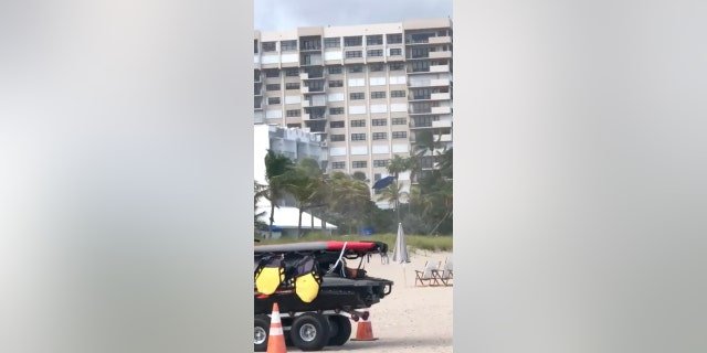 Blue beach umbrellas can be seen flying through the air during a storm in Florida.
