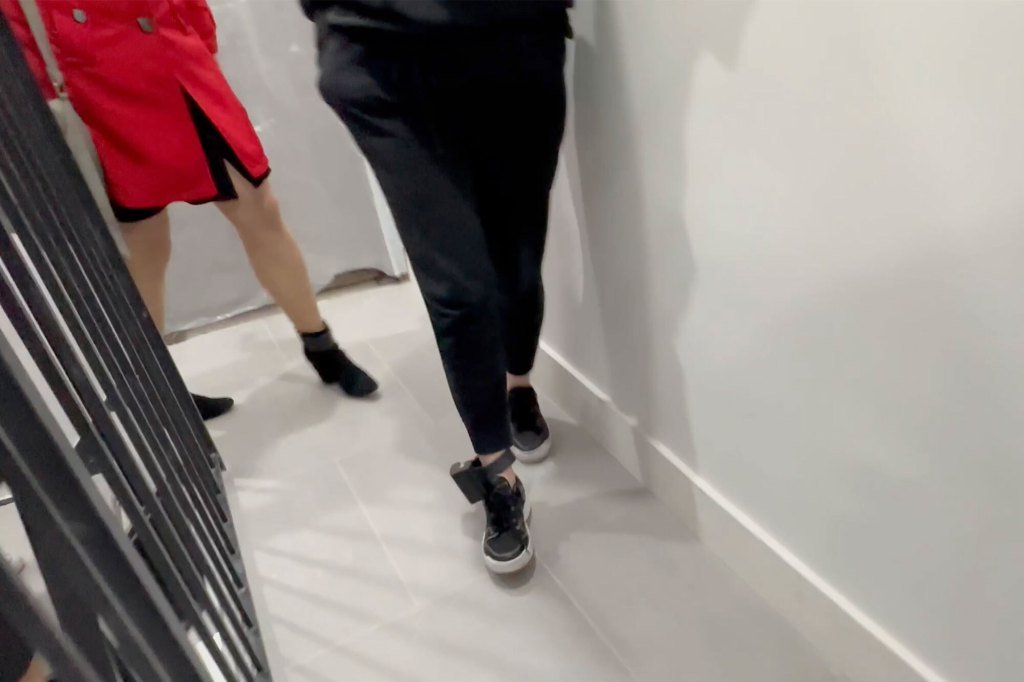 Sorokin arrives at the apartment seemingly wearing an ankle monitor.