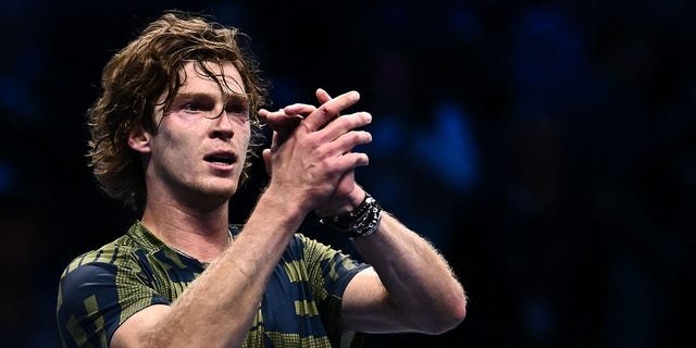 Andrey Rublev acknowledges the public after winning his match against Daniil Medvedev on Nov. 14, 2022, in Turin.