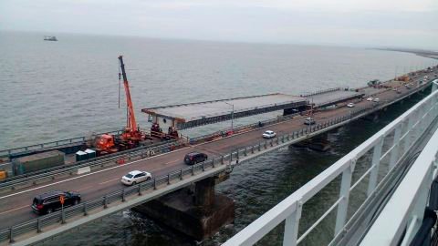 Workers pictured repairing damage to the bridge on November 19.