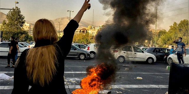 Iranians protest the death of 22-year-old Mahsa Amini after she was detained by the morality police, in Tehran, Oct. 1, 2022. 