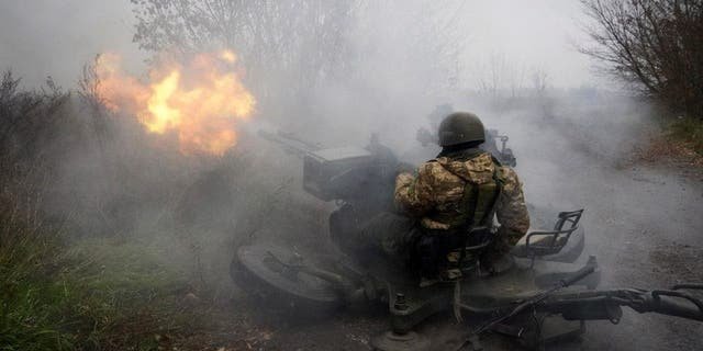 Ukrainian National guard soldiers fire at Russian positions from an anti-aircraft gun in Kharkiv region, Ukraine, Friday, Nov. 11, 2022.