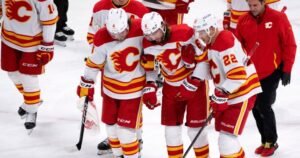 Calgary Flames defenceman Chris Tanev leaves game after taking shot to head