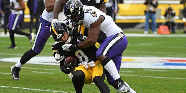 Pittsburgh Steelers quarterback Kenny Pickett (8) is tackled by Baltimore Ravens linebacker Roquan Smith during the first half in Pittsburgh, Sunday, Dec. 11, 2022.