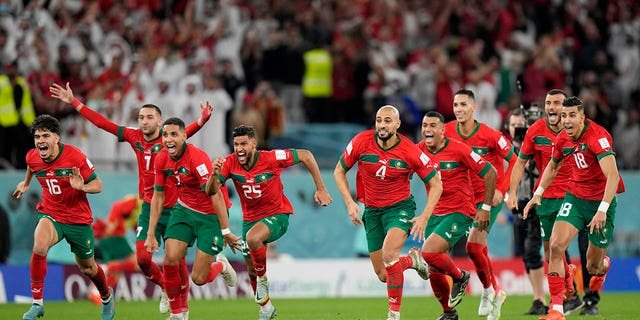 Morocco's players celebrate after a penalty shootout at a World Cup round of 16 soccer match against Spain at the Education City Stadium in Al Rayyan, Qatar, Tuesday, Dec. 6, 2022.