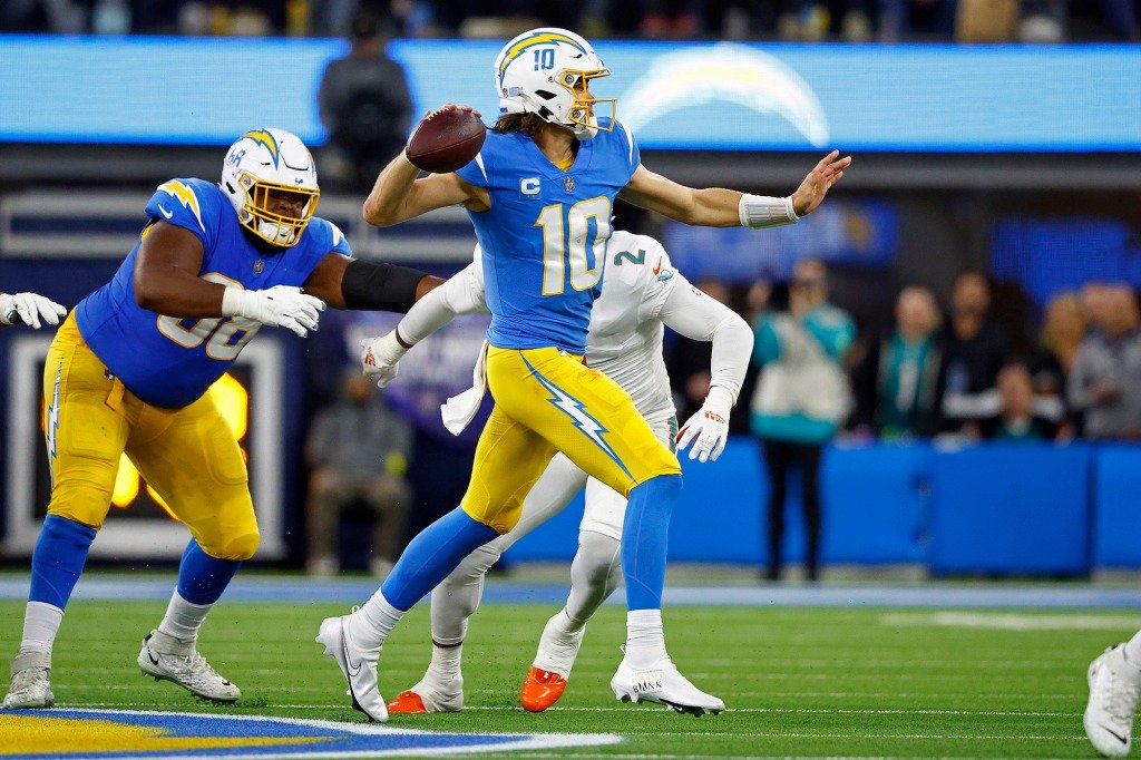 Justin Herbert #10 of the Los Angeles Chargers passes during a game against the Miami Dolphins at SoFi Stadium on December 11, 2022.