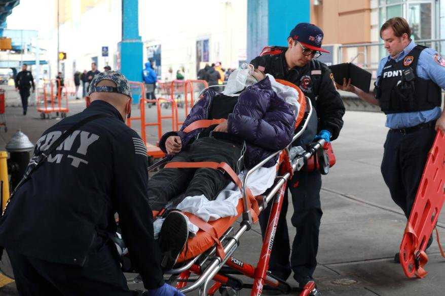A picture of rescue teams trying to reach two people that fell down an elevator shaft.