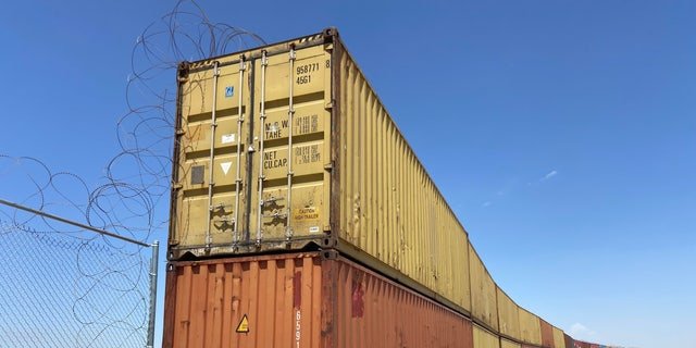 Construction to place these shipping containers in gaps in the border wall began in Yuma, Arizona. Republican Gov. Doug Ducey of Arizona is suing the federal government over an order to remove shipping containers used to fill gaps at the southern border.