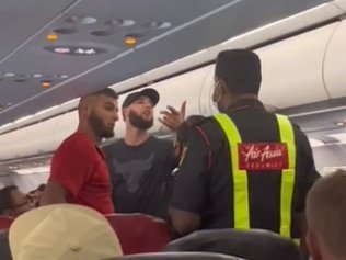 Wild video shows moment Aussie travellers are booted off AirAsia flight as they hurl abuse at cabin crew and passengers