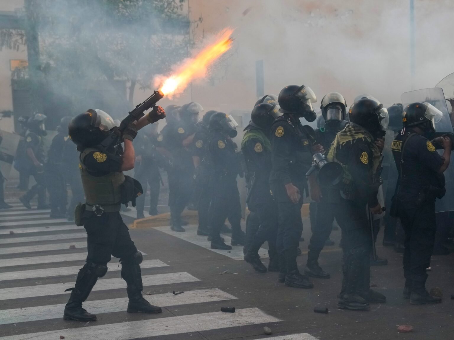 Photos: Protesters, police clash; Peru president calls for truce