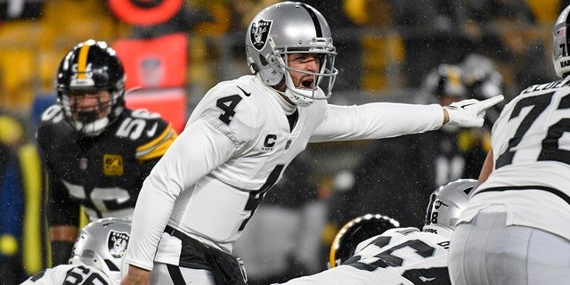 Las Vegas Raiders quarterback Derek Carr, #4, calls signals during the first half of an NFL football game against the Pittsburgh Steelers in Pittsburgh, Saturday, Dec. 24, 2022.