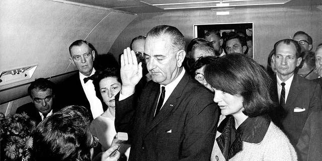 In the aftermath of the assassination of President John F. Kennedy, Vice President Lyndon Baines Johnson (1908-1973) takes the oath of office to become the 36th president. He was sworn in by U.S. Judge Sarah T. Hughes (1896-1985) on Air Force One in Dallas, Texas, on Nov. 22, 1963, as Kennedy's widow, Jacqueline Lee Bouvier Kennedy stood beside him.