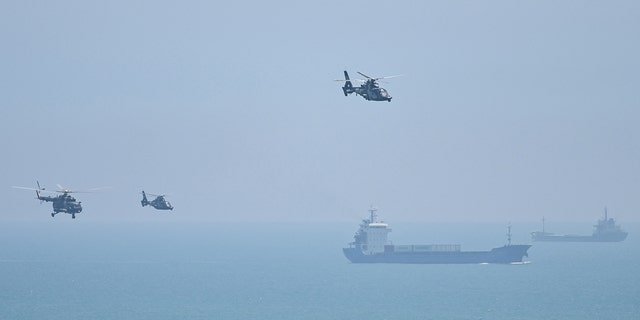 TOPSHOT - Chinese military helicopters fly past Pingtan island, one of mainland China's closest point from Taiwan, in Fujian province on August 4, 2022.