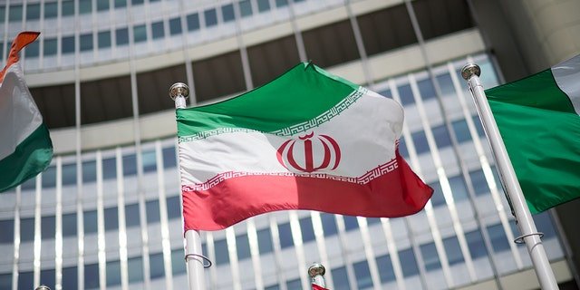 The flag of Iran in front of the International Atomic Energy Agency (IAEA) headquarters ahead of a press conference by Rafael Grossi, director general of the IAEA, about the agency's monitoring of Iran's nuclear energy program May 24, 2021, in Vienna, Austria.