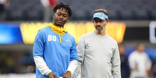 Maurice French of the Los Angeles Chargers, left, with offensive coach Shane Day during warmups ahead of a game against the New England Patriots at SoFi Stadium Oct. 31, 2021, in Inglewood, Calif.