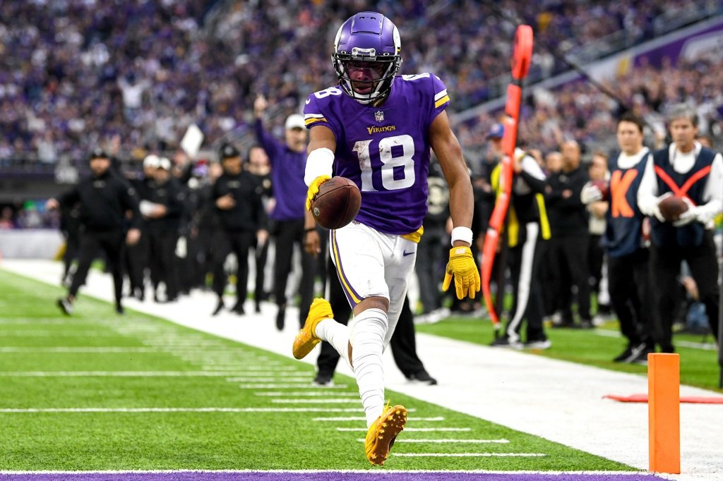 Justin Jefferson #18 of the Minnesota Vikings scores a touchdown against the Indianapolis Colts during the fourth quarter of the game at U.S. Bank Stadium on December 17, 2022 in Minneapolis, Minnesota. 
