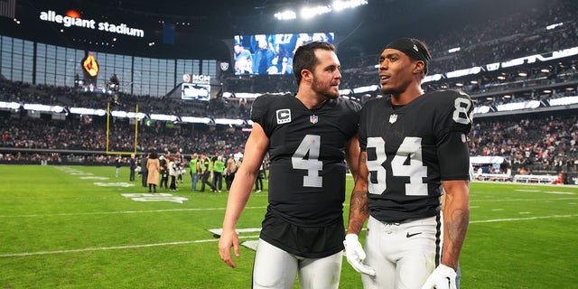 Las Vegas Raiders quarterback Derek Carr, #4, speaks to wide receiver Keelan Cole, #84, after their victory against the New England Patriots at Allegiant Stadium on Dec. 18, 2022 in Las Vegas. The Raiders defeated the Patriots 30-24.