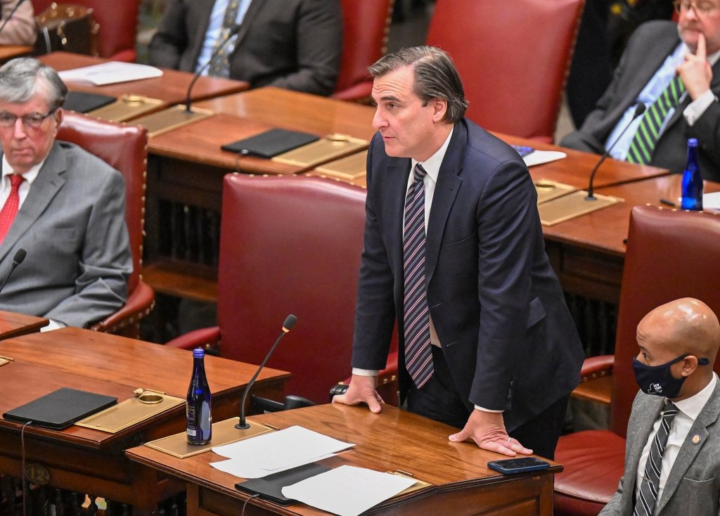 Gianaris standing at his desk in state Senate chamber