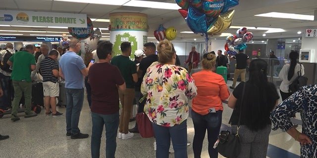 Hundreds of migrants wait to reunite with family at the Miami International Airport.