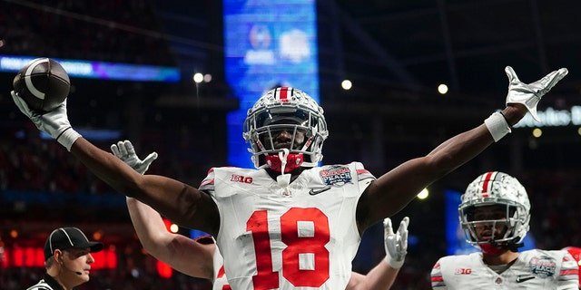 Ohio State wide receiver Marvin Harrison Jr. celebrates his touchdown catch against Georgia during the first half of the Peach Bowl Dec. 31, 2022, in Atlanta.