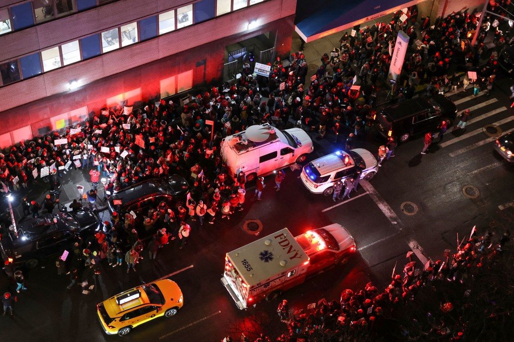 A massive crowd of nurses walk off the job and crowd the street outside Mount Sinai Hospital early Monday.