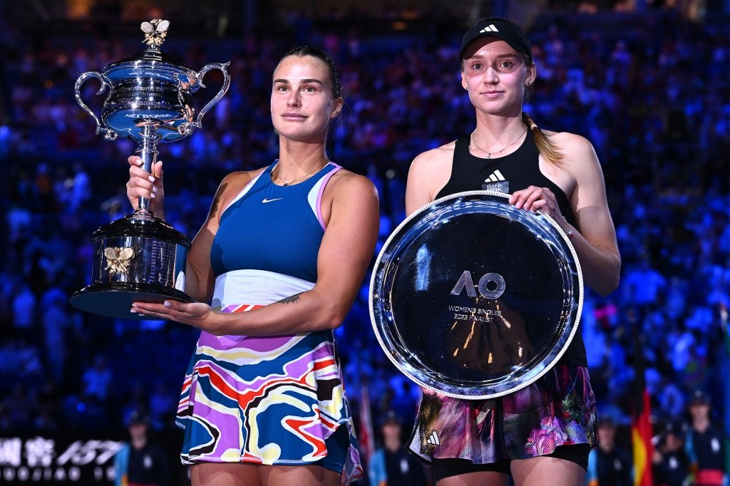 Sabalenka poses with the Daphne Akhurst Memorial Cup and Elena Rybakina of Kazakhstan poses with a trophy after the Women’s Singles Final match during day 13 of the 2023 Australian Open at Melbourne Park on January 28, 2023 in Melbourne, Australia.