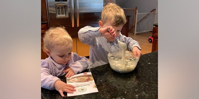Chicago mom Beverly watches as her children make their own sourdough bread at home.