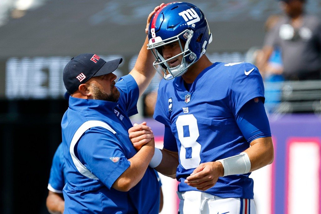 Daniel Jones #8 of the New York Giants speaks with head coach Brian Daboll of the New York Giants before the game against the Carolina Panthers at MetLife Stadium on September 18, 2022 in East Rutherford, New Jersey.