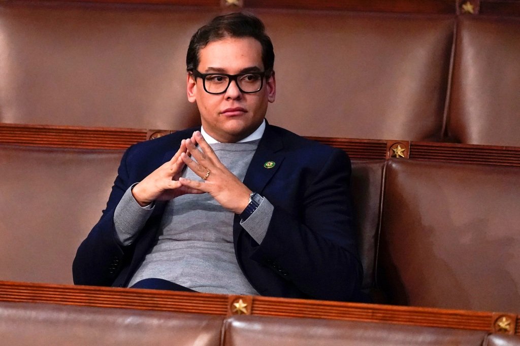 Santos sits alone on the House floor