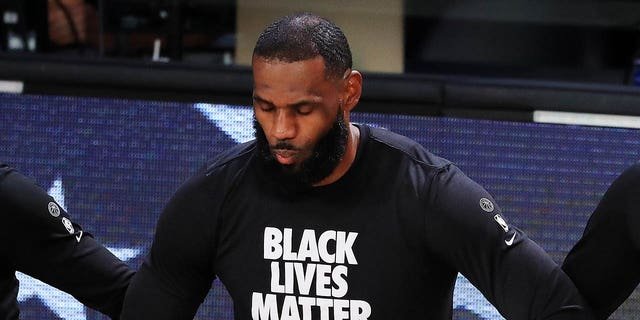 LeBron James of the Los Angeles Lakers kneels during the national anthem prior to the start of a game against the Houston Rockets in Game 5 of the Western Conference second round during the 2020 NBA Playoffs Sept. 12, 2020, in Lake Buena Vista, Fla.