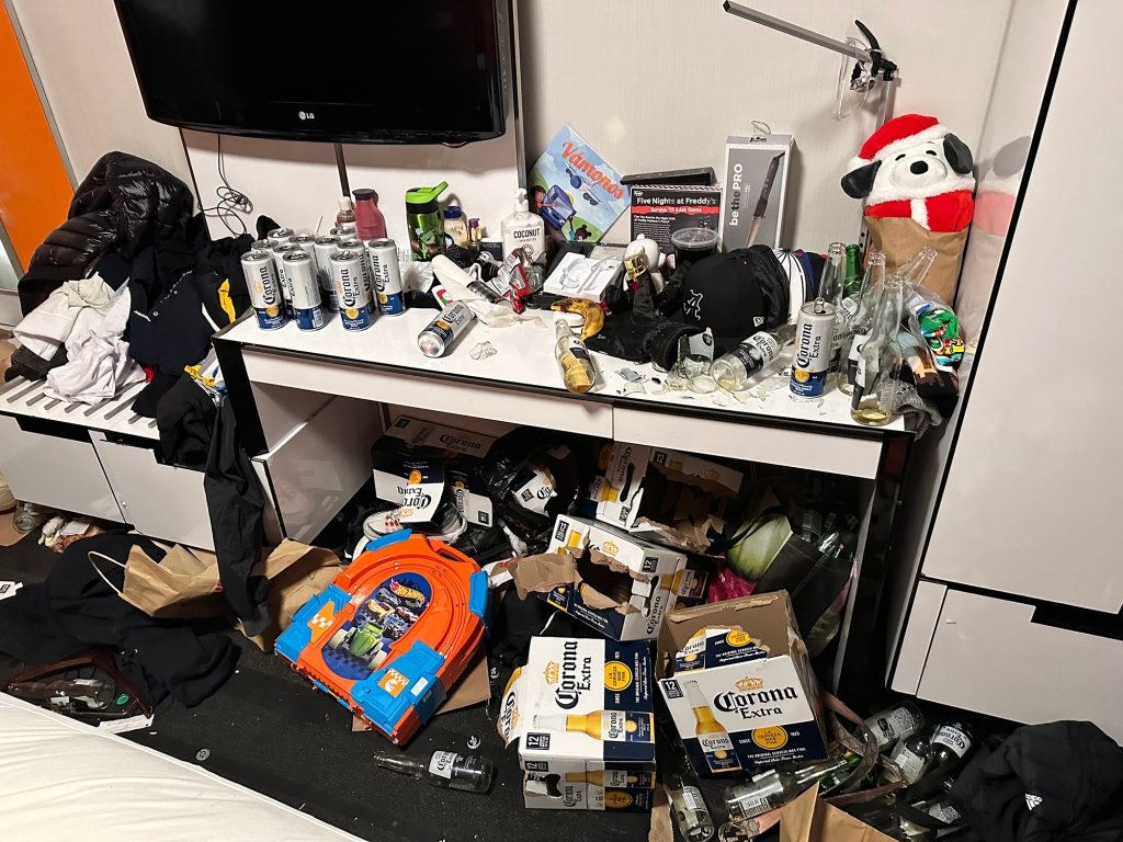 A hotel room covered in empty beer cans and bottles after several migrants had a World Cup party.