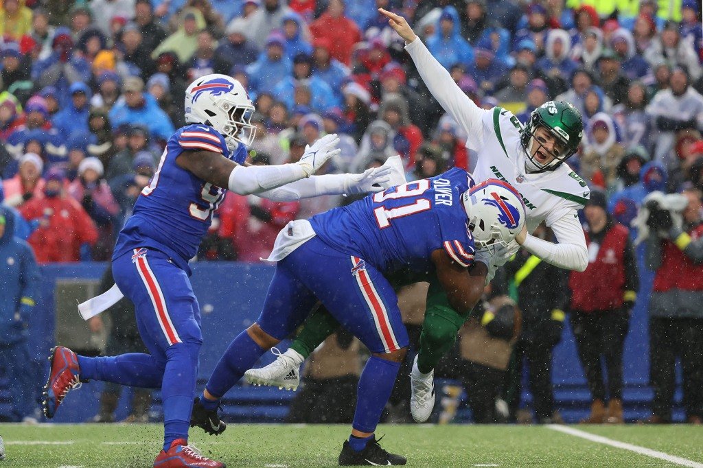 Mike White #5 of the New York Jets is tackled by Ed Oliver #91 of the Buffalo Bills just as he throws the ball during the second quarter.