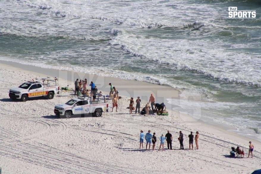 Former NFL star Peyton Hillis receiving medical attention on the beach after a swimming accident in Pensacola, Florida on Jan. 4, 2023.