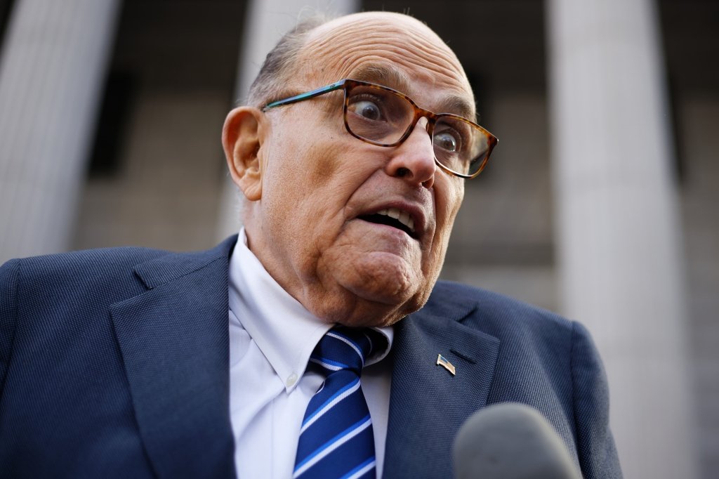 Rudy Giuliani is pictured talking outside of a court building.