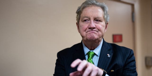 Sen. John Kennedy, R-La., stops to talk to reporters as he arrives in the Capitol from the Senate subway on Wednesday, Jan. 25, 2023.