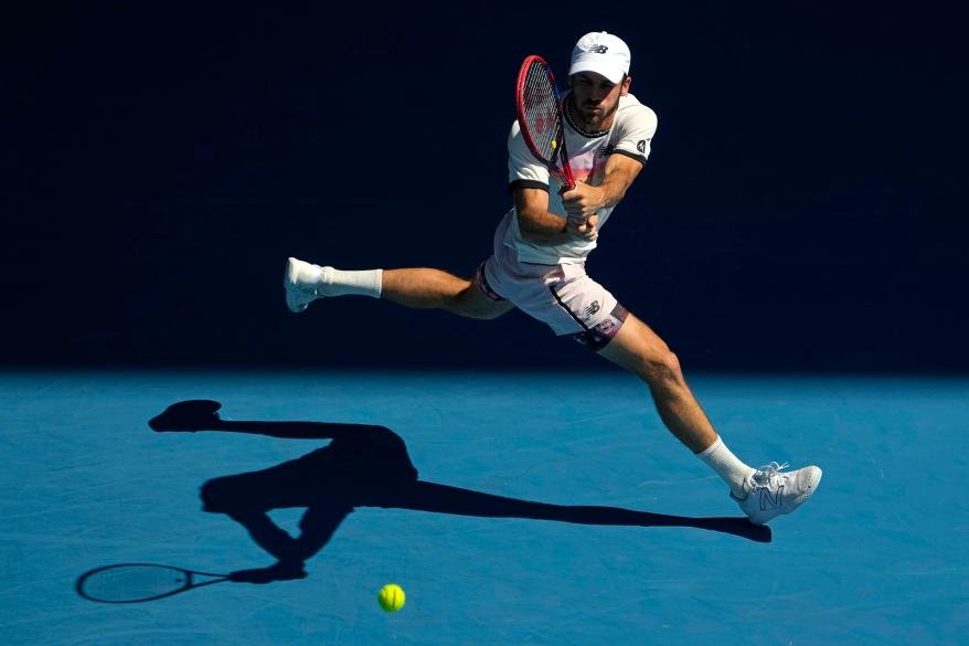 Tommy Paul plays a backhand return to Ben Shelton during their quarterfinal match at the Australian Open on Jan. 25, 2023.