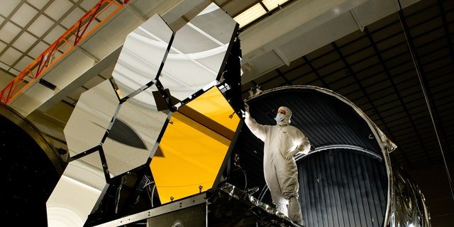 Ball Aerospace lead optical test engineer Dave Chaney inspects six primary mirror segments, critical elements of NASA's James Webb Space Telescope, prior to cryogenic testing in the X-ray & Cryogenic Facility at NASA's Marshall Space Flight Center in Huntsville, Ala.