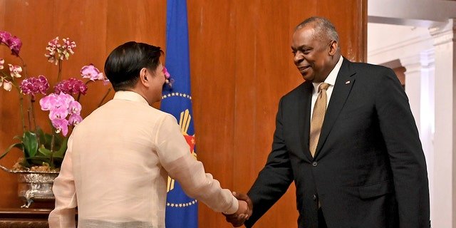 U.S. Secretary of Defense Lloyd James Austin III, right, shake hands with Philippine President Ferdinand Marcos Jr. during a courtesy call at the Malacanang Palace in Manila, Philippines on Thursday, Feb. 2, 2023.