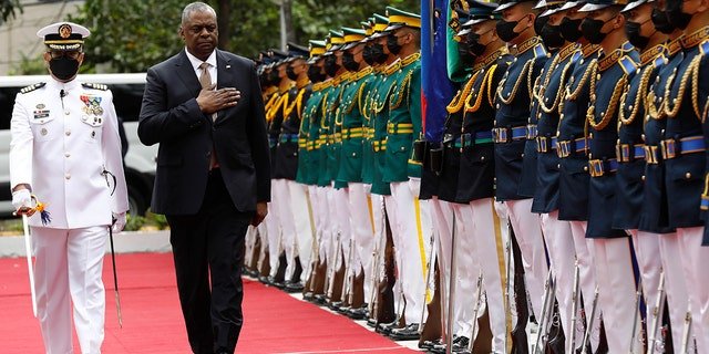 U.S. Defense Secretary Lloyd Austin, second from left, walks past military guards during his arrival at the Department of National Defense in Camp Aguinaldo military camp in Quezon City, Metro Manila, Philippines on Thursday February 2, 2023.