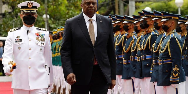 U.S. Defense Secretary Lloyd Austin, second from left, walks past military guards during his arrival at the Department of National Defense in Camp Aguinaldo military camp in Quezon City, Metro Manila, Philippines on Thursday February 2, 2023.
