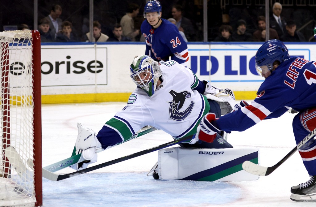 Alexis Lafreniere scores a goal on Spencer Martin during the second period of the Rangers' win.