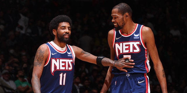 Kyrie Irving, #11, talks to Kevin Durant, #7 of the Brooklyn Nets, during Round 1 Game 4 of the 2022 NBA Playoffs on April 25, 2022 at Barclays Center in Brooklyn, New York. 