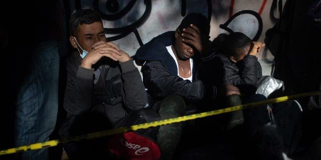 Migrants from Venezuela, Cuba, Haiti and Afghanistan wait in line outside at the Mexican Commission for Refugee Assistance in Mexico City Jan. 24, 2023.