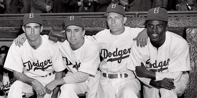 From left, Brooklyn Dodgers third baseman John Jorgensen, shortstop Pee Wee Reese, second baseman Ed Stanky and first baseman Jackie Robinson before a baseball game against the Boston Braves at Ebbets Field in Brooklyn, New York, on April 15, 1947.