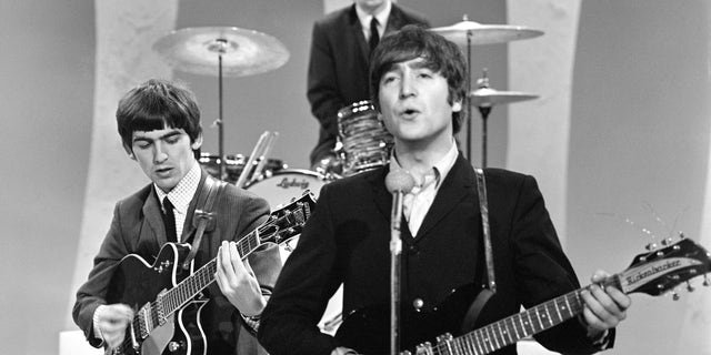 John Lennon played his prized 1958 Rickenbacker 325 when the Beatles first played "The Ed Sullivan Show' on Sunday, Feb. 9, 1964, from CBS's Studio 50 in New York City. Three of the four band members are shown here (from left): George Harrison, Ringo Starr (drummer) and John Lennon.
