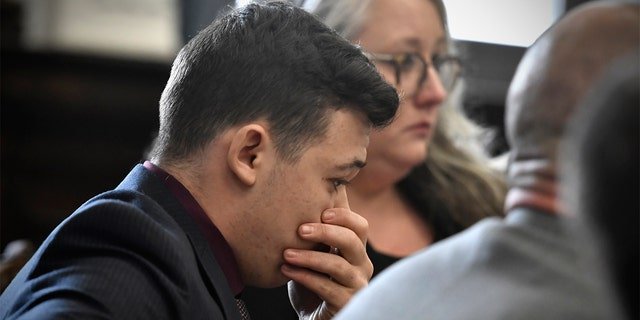 Kyle Rittenhouse puts his hand over his face after he is found not guilt on all counts at the Kenosha County Courthouse in Kenosha, Wis., on Friday, Nov. 19, 2021.